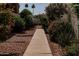 Charming walkway surrounded by vibrant, colorful landscaping and leading to the home at 630 E Jensen St # 116, Mesa, AZ 85203