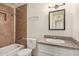 Well-lit bathroom featuring a tiled shower/tub combo and granite vanity at 6312 N 41St Ave, Phoenix, AZ 85019