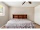 Bedroom with hardwood floors, a ceiling fan and a large bed with built in bookcase headboard at 6312 N 41St Ave, Phoenix, AZ 85019