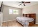 Bedroom with hardwood floors, a ceiling fan and a large bed with built in bookcase headboard at 6312 N 41St Ave, Phoenix, AZ 85019