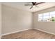Bedroom with hardwood floors, a ceiling fan and a window showing greenery and natural light at 6312 N 41St Ave, Phoenix, AZ 85019