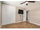Bedroom featuring hardwood floors, a ceiling fan, closet doors and a television mounted on the wall at 6312 N 41St Ave, Phoenix, AZ 85019