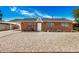 Charming brick home featuring a well-maintained front yard with a classic design and a covered carport on the left at 6312 N 41St Ave, Phoenix, AZ 85019