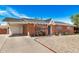 Cozy brick house with a covered parking area and a tidy gravel front yard, complete with a charming white front door at 6312 N 41St Ave, Phoenix, AZ 85019