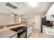 The kitchen includes an electric range, tan countertops, and a breakfast bar with seating into another room at 6312 N 41St Ave, Phoenix, AZ 85019