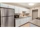 Bright kitchen features white cabinets, granite countertops, a stainless steel refrigerator and undermounted sink at 6312 N 41St Ave, Phoenix, AZ 85019