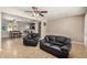 Open living area featuring tile flooring, a ceiling fan, and a bar area leading to the kitchen for easy entertaining at 6312 N 41St Ave, Phoenix, AZ 85019