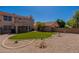 Expansive backyard showcasing desert landscaping, trees, and a plush artificial lawn at 6462 E Raftriver St, Mesa, AZ 85215