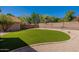 Large backyard featuring an artificial lawn, desert landscaping and a block wall at 6462 E Raftriver St, Mesa, AZ 85215