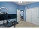 Bright bedroom with blue walls, carpet flooring, desk, and direct access to the bathroom at 6462 E Raftriver St, Mesa, AZ 85215
