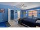 Bright bedroom with blue walls, carpet flooring, and a ceiling fan for added comfort at 6462 E Raftriver St, Mesa, AZ 85215