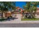Two-story home featuring a red tile roof, a well-manicured lawn, and a spacious two-car garage at 6462 E Raftriver St, Mesa, AZ 85215