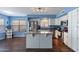 Bright kitchen featuring white cabinets, stainless steel appliances, and an island at 6462 E Raftriver St, Mesa, AZ 85215