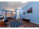Open-concept room with hardwood floors, a striking blue accent wall, and a bright front door at 6462 E Raftriver St, Mesa, AZ 85215