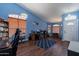 Open-concept room with hardwood floors, a striking blue accent wall, and a bright front door at 6462 E Raftriver St, Mesa, AZ 85215