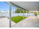 Spacious covered patio with tile flooring, overlooking the lush green turf and well-manicured yard at 6739 E Thunderbird Rd, Scottsdale, AZ 85254