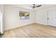 Bright bedroom features wood flooring, a modern ceiling fan, and white walls at 6739 E Thunderbird Rd, Scottsdale, AZ 85254