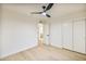 Bright bedroom features wood flooring, a modern ceiling fan, and white walls at 6739 E Thunderbird Rd, Scottsdale, AZ 85254