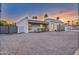 Single-story home showing the side with desert landscaping and a block fence at 6739 E Thunderbird Rd, Scottsdale, AZ 85254