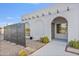 Inviting arched entrance of a single-story home with desert landscaping and a concrete walkway at 6739 E Thunderbird Rd, Scottsdale, AZ 85254
