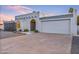 Inviting single-story home with stucco walls, arched entryway, and a spacious two-car garage at 6739 E Thunderbird Rd, Scottsdale, AZ 85254