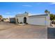 Charming single-story home featuring a large garage, concrete driveway, and desert landscaping at 6739 E Thunderbird Rd, Scottsdale, AZ 85254
