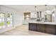 Modern kitchen with stainless steel appliances, white cabinets, and a stylish island, ideal for cooking at 6739 E Thunderbird Rd, Scottsdale, AZ 85254