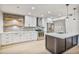 Bright kitchen with white cabinetry, stainless steel appliances, and a stylish island with sink at 6739 E Thunderbird Rd, Scottsdale, AZ 85254