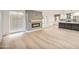 Open-concept living area with fireplace, hardwood floors, and a seamless flow to the modern kitchen at 6739 E Thunderbird Rd, Scottsdale, AZ 85254
