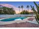 Sparkling pool surrounded by lush landscaping and tall palm trees, creating a serene outdoor retreat at 6739 E Thunderbird Rd, Scottsdale, AZ 85254