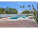 Private backyard pool is surrounded by lush landscaping and tall palm trees, creating a tropical escape at 6739 E Thunderbird Rd, Scottsdale, AZ 85254