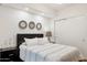 Bright bedroom with modern decor featuring a queen bed, side table and recessed lighting at 7151 E Rancho Vista Dr # 3001, Scottsdale, AZ 85251
