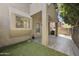 Backyard with artificial turf, view of multi story home and covered patio at 7240 N Dreamy Draw Dr # 109, Phoenix, AZ 85020