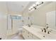 Bright bathroom featuring a double vanity, large mirror, and glass-enclosed shower at 7240 N Dreamy Draw Dr # 109, Phoenix, AZ 85020