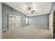 Large room featuring carpeted floors, ceiling fan, and louvered windows at 7240 N Dreamy Draw Dr # 109, Phoenix, AZ 85020