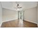 Large bedroom with a ceiling fan, wood floors, and sliding glass doors leading to the outside at 7240 N Dreamy Draw Dr # 109, Phoenix, AZ 85020