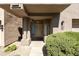 Inviting front entrance with stone pathway, lush greenery, and decorative glass block window at 7240 N Dreamy Draw Dr # 109, Phoenix, AZ 85020