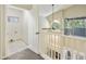 Upstairs hallway with white railing, tile-floor laundry room, and large window at 7240 N Dreamy Draw Dr # 109, Phoenix, AZ 85020
