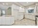 Bright kitchen featuring granite countertops, white cabinetry, and stainless-steel appliances at 7240 N Dreamy Draw Dr # 109, Phoenix, AZ 85020