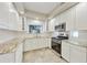 Bright kitchen with white cabinetry, stainless-steel appliances, and granite countertops at 7240 N Dreamy Draw Dr # 109, Phoenix, AZ 85020