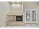Cozy fireplace with tile surround and french doors leading to an outdoor space at 7240 N Dreamy Draw Dr # 109, Phoenix, AZ 85020