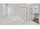 Enclosed glass shower and separate soaking tub in a well-lit main bathroom at 7240 N Dreamy Draw Dr # 109, Phoenix, AZ 85020