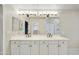 Main bathroom double sink vanity with white cabinets and black hardware at 7240 N Dreamy Draw Dr # 109, Phoenix, AZ 85020