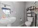 A pedestal sink, oval mirror and toilet create a functional powder room at 820 N 8Th Ave # 25, Phoenix, AZ 85007