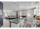 A kitchen island with a sink opens to the dining and living area at 820 N 8Th Ave # 25, Phoenix, AZ 85007
