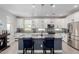 Modern kitchen featuring white cabinets, stainless steel appliances, a gray island, and stylish pendant lighting at 820 N 8Th Ave # 25, Phoenix, AZ 85007