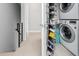 Well-organized laundry area with stacked washer and dryer and storage on door at 820 N 8Th Ave # 25, Phoenix, AZ 85007