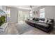 Living room with gray tile, large sectional sofa, and sliding glass doors at 820 N 8Th Ave # 25, Phoenix, AZ 85007
