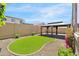 Lush backyard with artificial turf, gravel, and covered patio at 8872 W Hollywood Ave, Peoria, AZ 85345