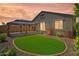 Backyard features a covered patio and lush artificial grass for easy maintenance at 8872 W Hollywood Ave, Peoria, AZ 85345